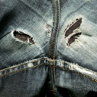 Denim fabric fills holes of blow-out areas in the jeans crotch